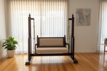 Load image into Gallery viewer, Wooden chair with beige cushion on a wooden floor in a room with furniture and decor.

